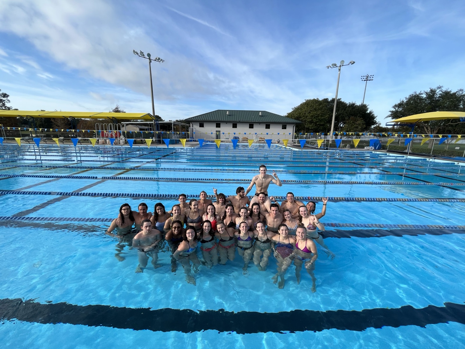 Maik with the swim team in the pool at SCAD